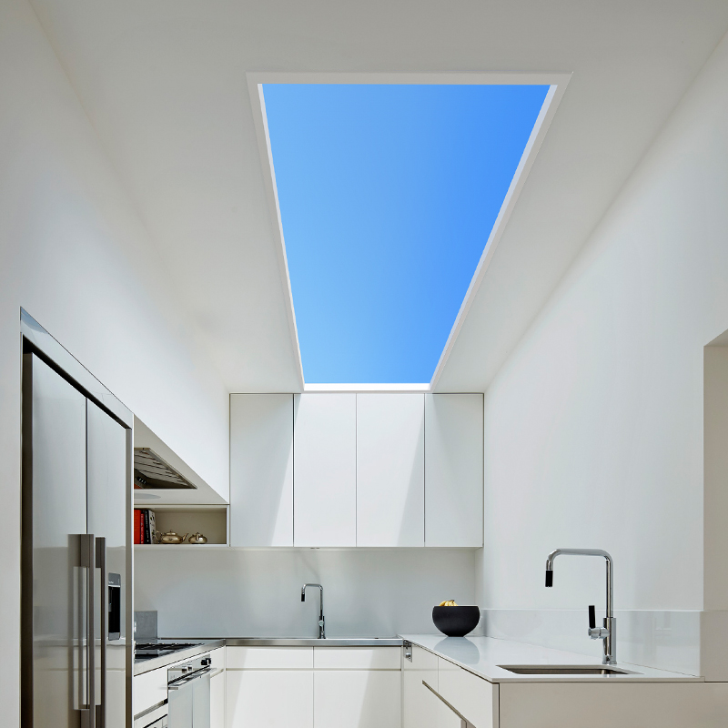 Artificial skylight above a white kitchen