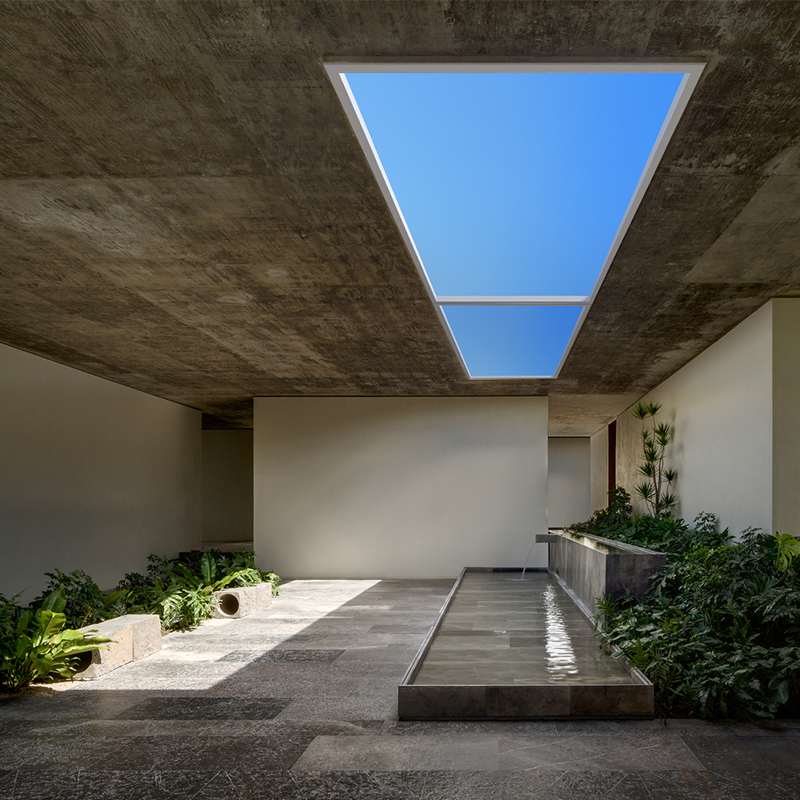 Two-panel artificial skylight above an indoor garden