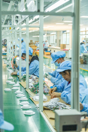 Workers assembling lighting products on a New Lights production line
