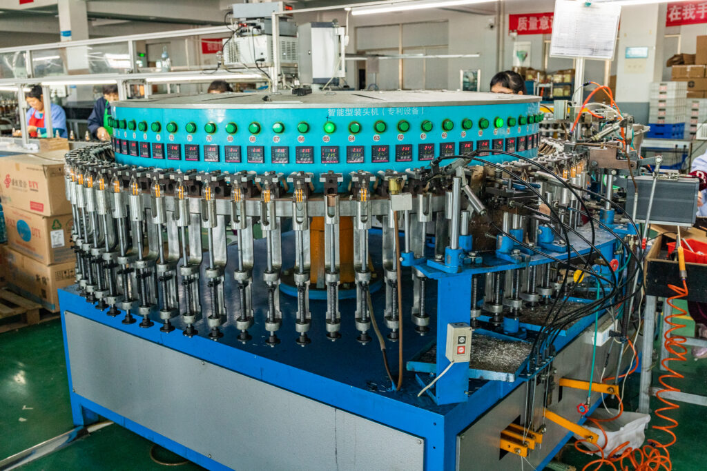 Automated lamp cap assembly equipment at the New Lights factory