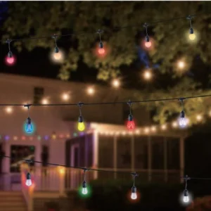 Verified outdoor decorative string-light installation with plausible downward bulb orientation, cable support and scale.