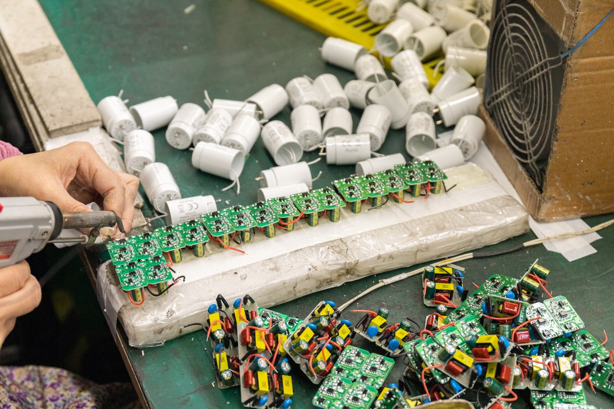 New Lights production operator soldering LED driver assemblies