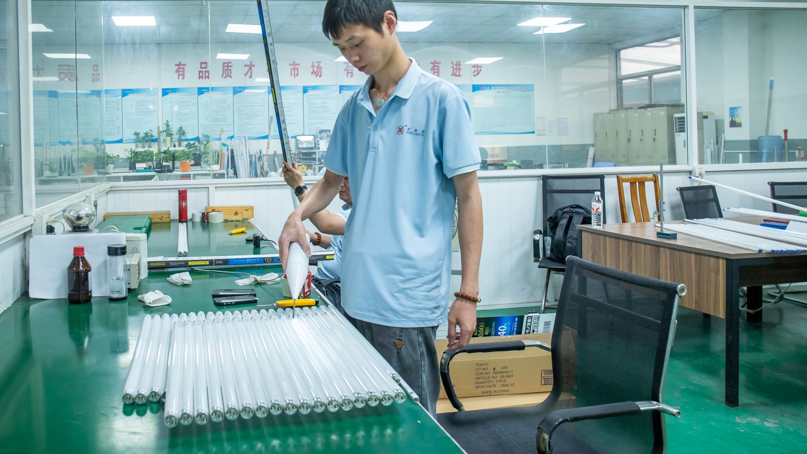 New Lights quality staff checking the dimensions of an LED tube