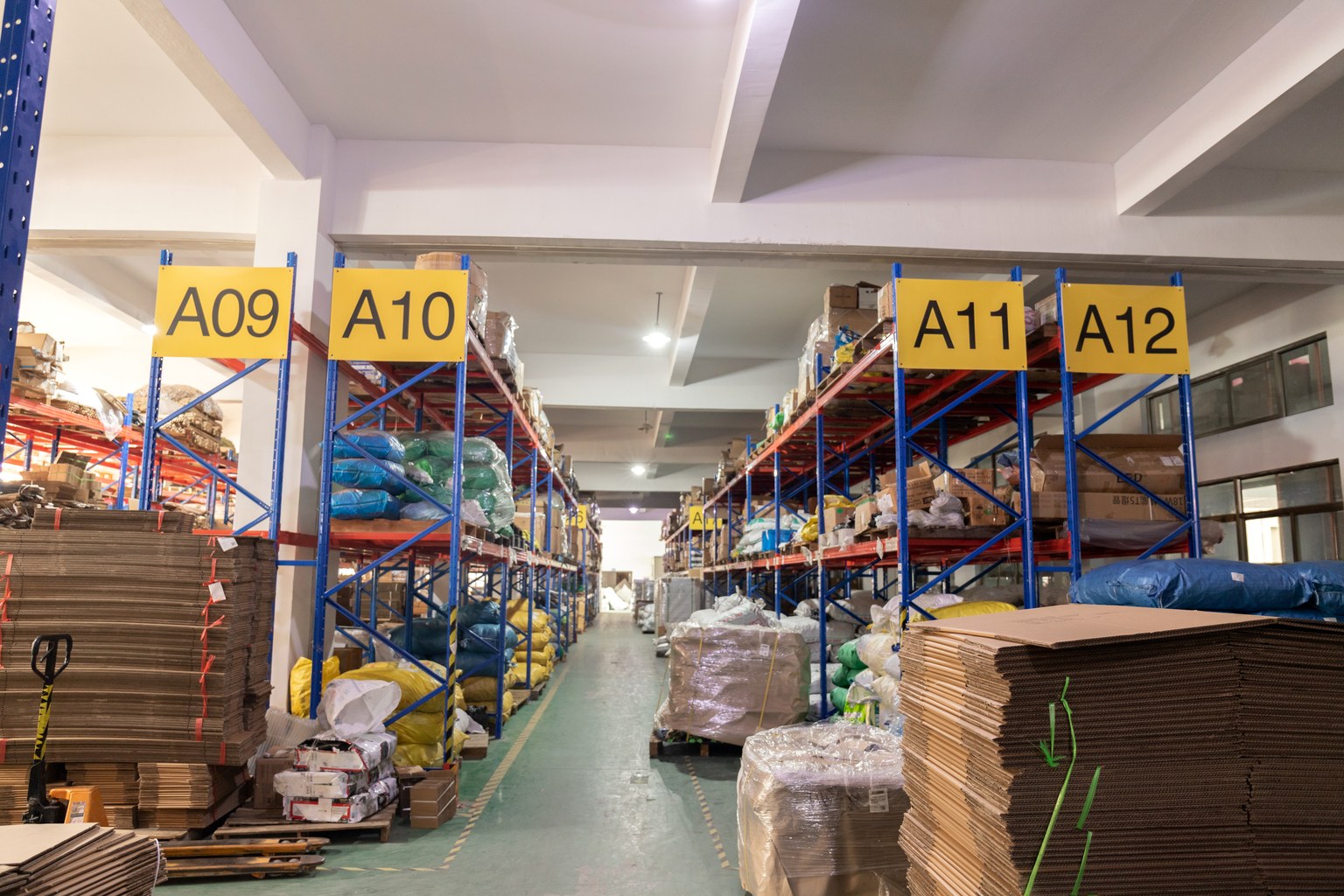 Packaging materials stored on labeled warehouse racks at New Lights