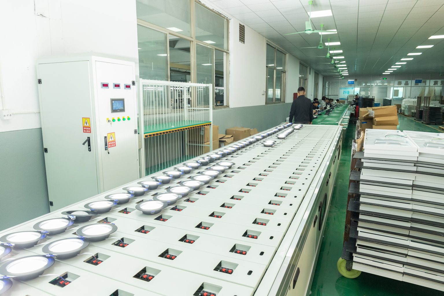 Small LED panel lights undergoing powered inspection at New Lights
