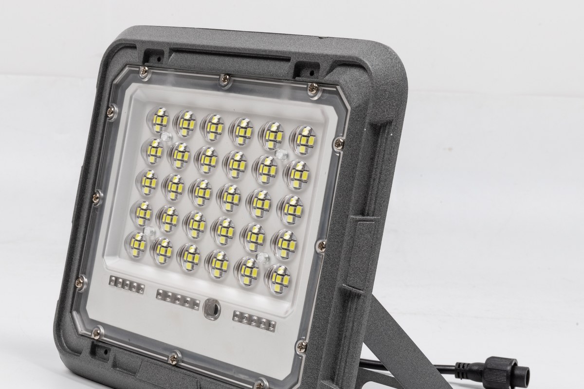 Close view of a New Lights LED solar flood light luminaire and adjustable mounting bracket
