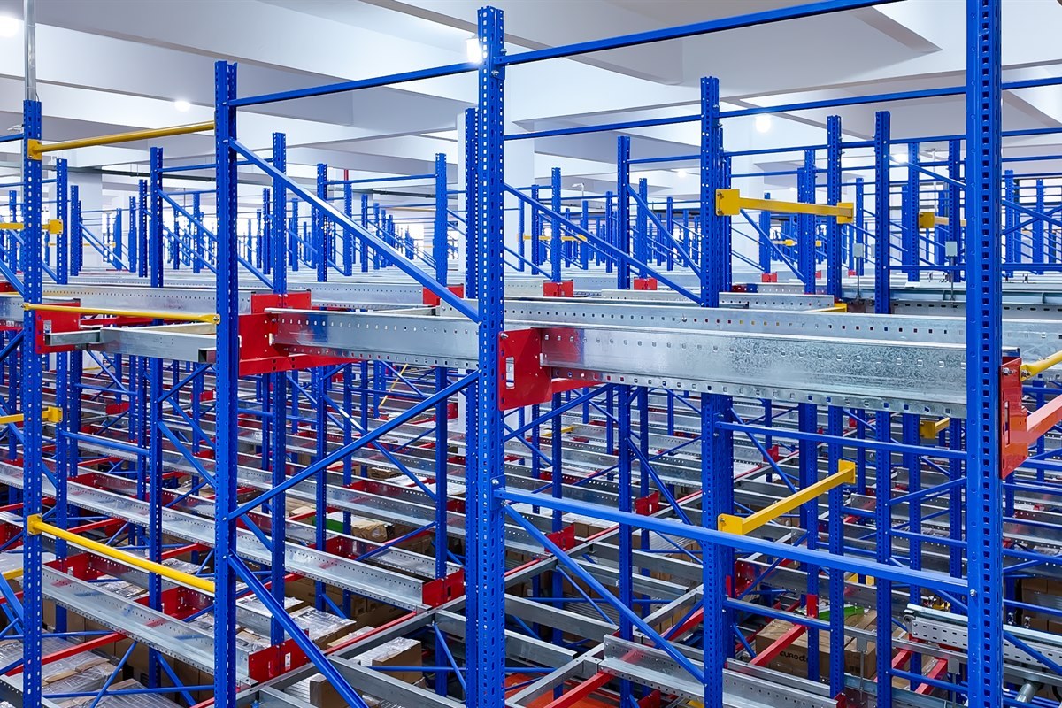 New Lights warehouse aisles with high storage racks and overhead lighting