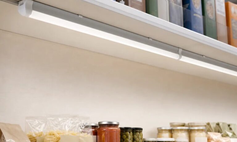 Linked T8 integrated LED fixtures illuminating a retail shelf